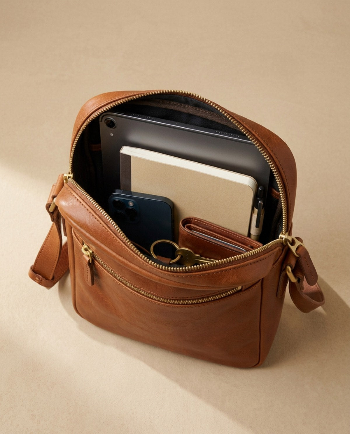 Marylebone Zip Messenger open, showing what fits inside