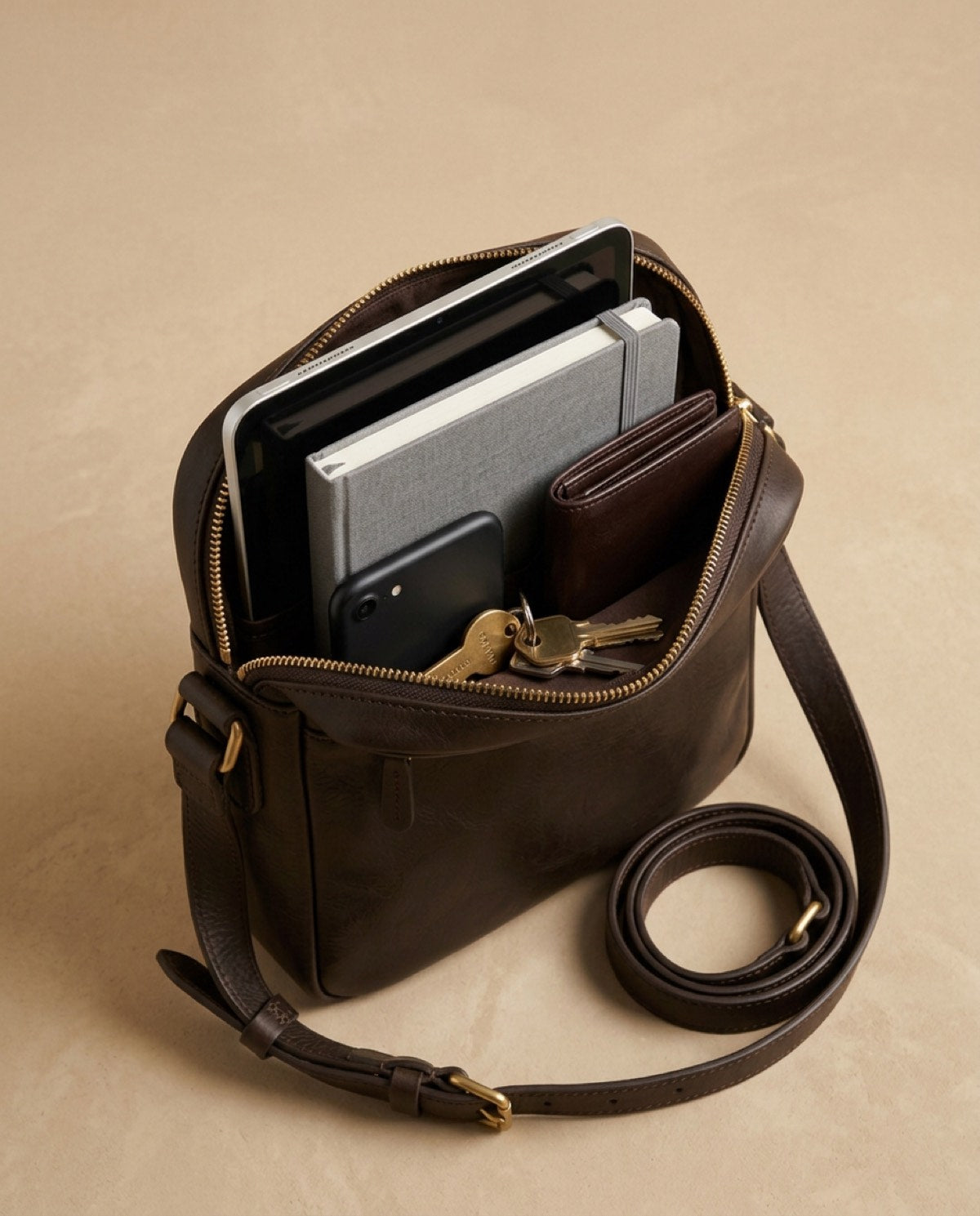 Marylebone Zip Messenger open, showing what fits inside